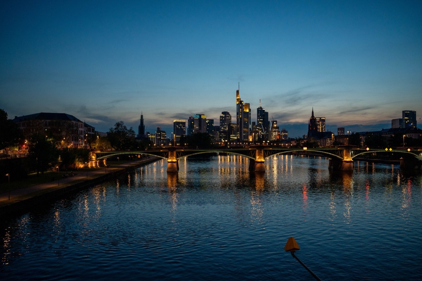 A city skyline across the river at dusk