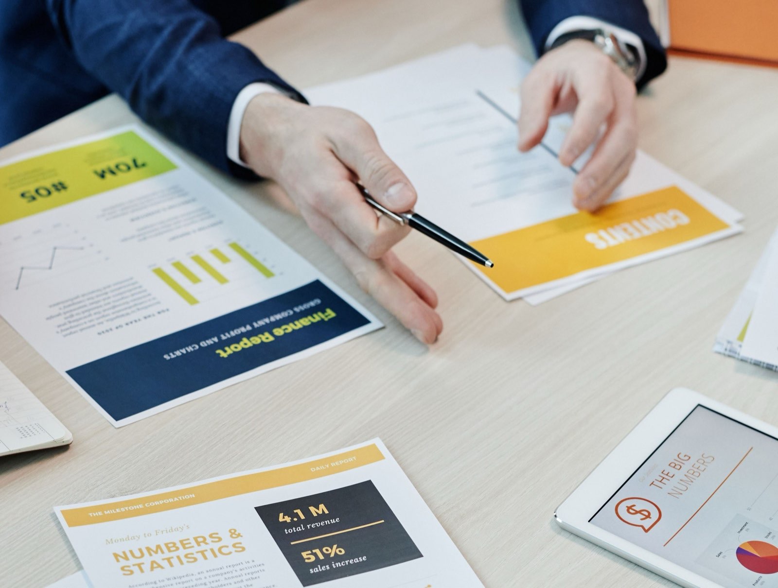 Financial reports and cash-flow plans laid out across a meeting table